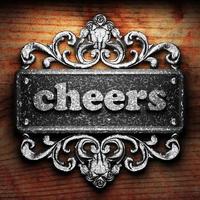 cheers word of iron on wooden background photo