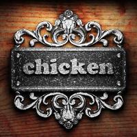 chicken word of iron on wooden background photo