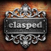 clasped word of iron on wooden background photo