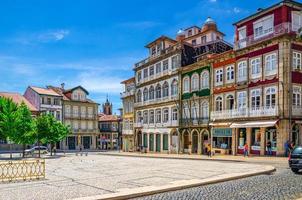 Guimaraes, Portugal - June 24, 2017 Largo do Toural square with colorful multicolored traditional typical buildings and houses in Guimaraes city historical centre photo