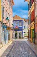Aveiro, Portugal, June 13, 2017 typical colorful azulejos-tiled buildings houses in cobblestone street of Aveiro city historical centre photo