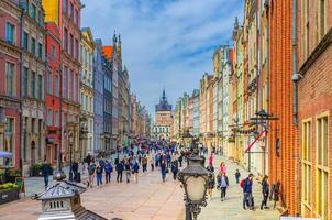 Gdansk, Poland, April 17, 2018 Golden gate Zlota Brama, Prison Tower, typical colorful houses buildings and people tourists walking down Dluga Street in Wroclaw photo