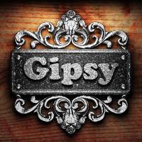 Gipsy word of iron on wooden background photo
