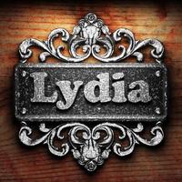 Lydia word of iron on wooden background photo