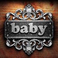 baby word of iron on wooden background photo