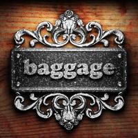 baggage word of iron on wooden background photo