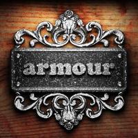 armour word of iron on wooden background photo
