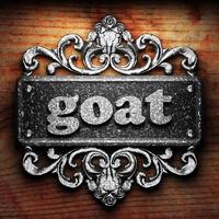 goat word of iron on wooden background photo