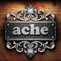 ache word of iron on wooden background photo