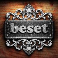 beset word of iron on wooden background photo