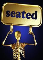 seated word and golden skeleton photo