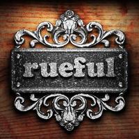 rueful word of iron on wooden background photo