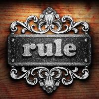 rule word of iron on wooden background photo