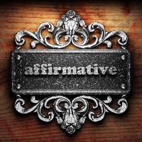 affirmative word of iron on wooden background photo