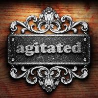 agitated word of iron on wooden background photo
