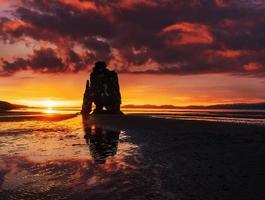 Is a spectacular rock in the sea on the Northern coast of Iceland. Legends say it is a petrified troll. On this photo Hvitserkur reflects in the sea water after the midnight sunset