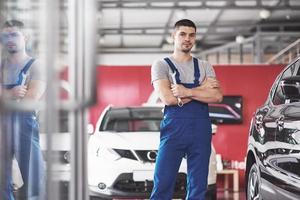 Hand of car mechanic with wrench. Auto repair garage photo