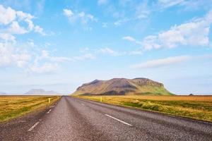 Asphalt road to the mountains Iceland. Beauty world photo