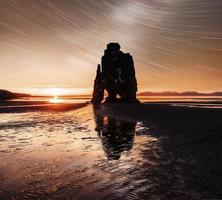 starry sky in a spectacular rock in the sea on the Northern coast of Iceland. Legends say it is a petrified troll photo