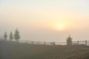 Foggy morning in the Ukrainian Carpathian Mountains in the autumn season photo