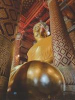 Ancient buddha statue in wat Thai or Thai temple. Giant Buddha god worship, Asian architecture art landmark, famous shrine for tourism. History spiritual temple of god. Travel Thailand attraction. photo