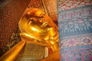 Ancient buddha statue in wat Thai or Thai temple. Giant Buddha god worship, Asian architecture art landmark, famous shrine for tourism. History spiritual temple of god. Travel Thailand attraction. photo