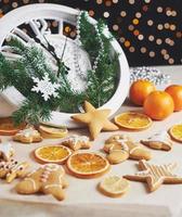 Happy New Year at midnight 2018, Old wooden clock with holiday lights and fir branches. Cooking and decorating christmas gingerbread cookies and fried orange slices photo