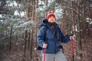 Man Traveler with backpack hiking Travel Lifestyle adventure concept active vacations outdoor. Beautiful landscape  forest photo