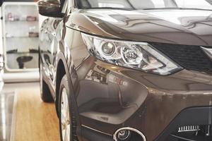 The headlights and the hood of a black luxury car photo