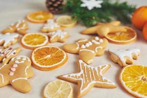 Decorating a spicy cookie with white glaze and orange. Happy New Year. photo