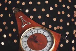 Happy New Year at midnight 2018, Old wooden clock with holiday lights photo