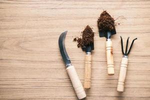 gardening tools and plant on a table with copy space photo