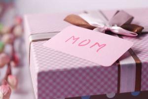 f mother day gift and flower on table. photo