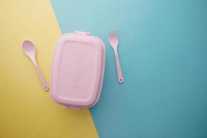 top view of a lunch box on color background photo