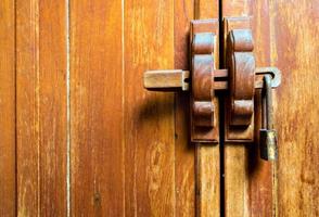 Wooden cabinet and lock at the door handle photo