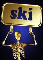 Golden skeleton holding the sign photo