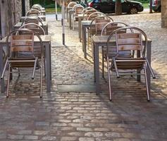 Tables of a cafe on the old city in the Spain. photo