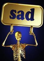 palabra triste y esqueleto dorado foto