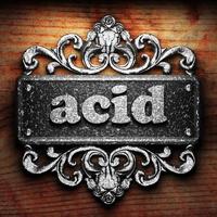 acid word of iron on wooden background photo