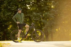 Young man riding ebike in nature photo