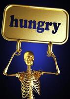 palabra hambrienta y esqueleto dorado foto
