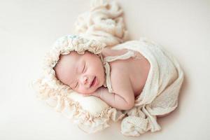 Happy newborn baby sleeping photo