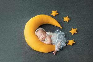 Asian newborn babay sleep with moon pillow photo