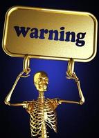 palabra de advertencia y esqueleto dorado foto