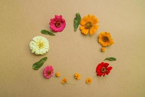 Beautiful flower flat lay arrangement on brown background. Flat lay bouquet, top view, overhead, empty space for copied text. photo