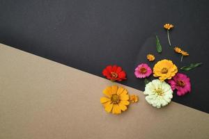 Beautiful flower flat lay arrangement on black and brown background. Flat lay bouquet, top view, overhead, empty space for copied text. photo