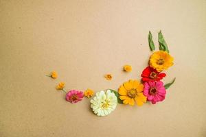 Beautiful flower flat lay arrangement on brown background. Flat lay bouquet, top view, overhead, empty space for copied text. photo