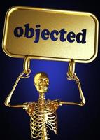 palabra objetada y esqueleto dorado foto