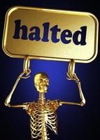 halted word and golden skeleton photo