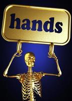 manos palabra y esqueleto dorado foto